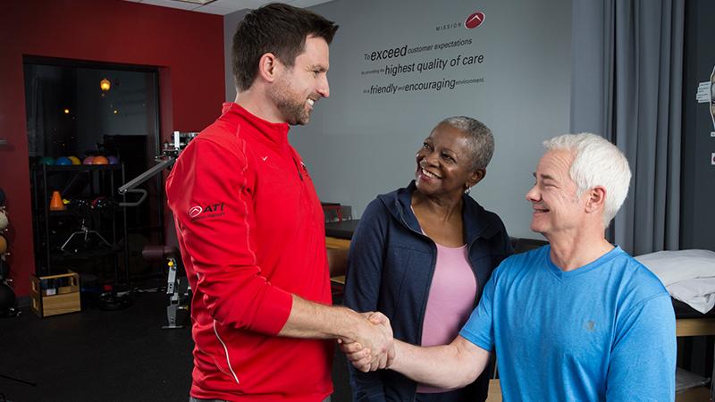 Therapist with two patients, shaking hands