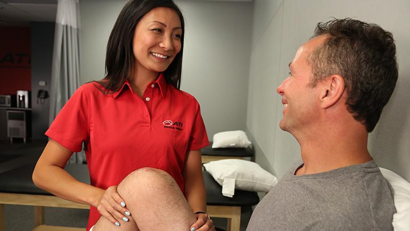 ATI therapist with a patient, working on knee