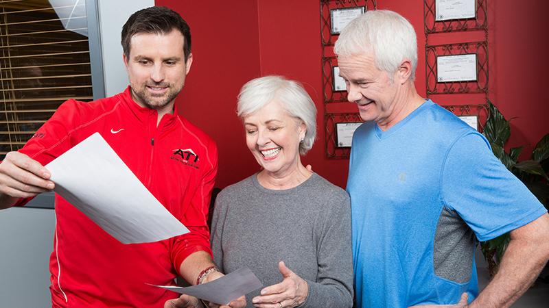 ATI staff reviewing results with two people